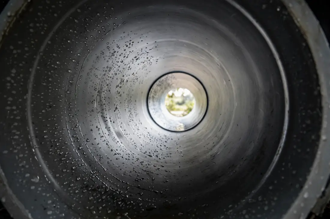 Clean interior of a drain pipe with water droplets